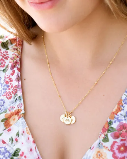 WOMAN WEARING 3 DISC NECKLACE