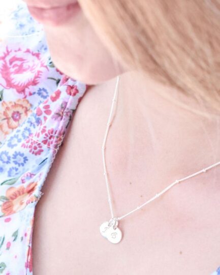 Engraved family name necklace with disc charms